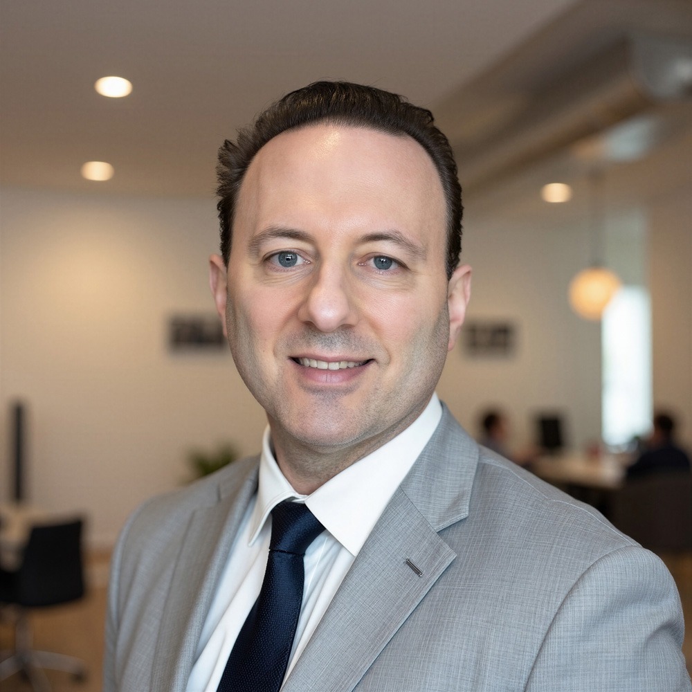 Howard Bernstein in a grey suit in an office